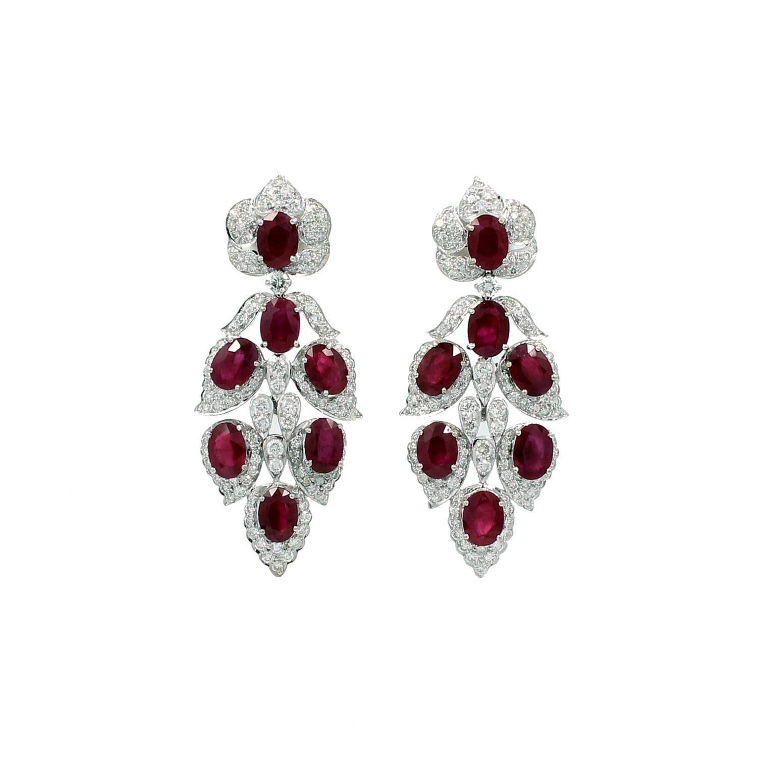 18K White Gold Earrings with 14 Oval Burma Rubies which equal 14.92 carats and Round Brilliant Diamonds which equal a total of 3.30 carats total weight. The earrings are 2 inches long and have a post with monster backs. Absolutely beautiful.