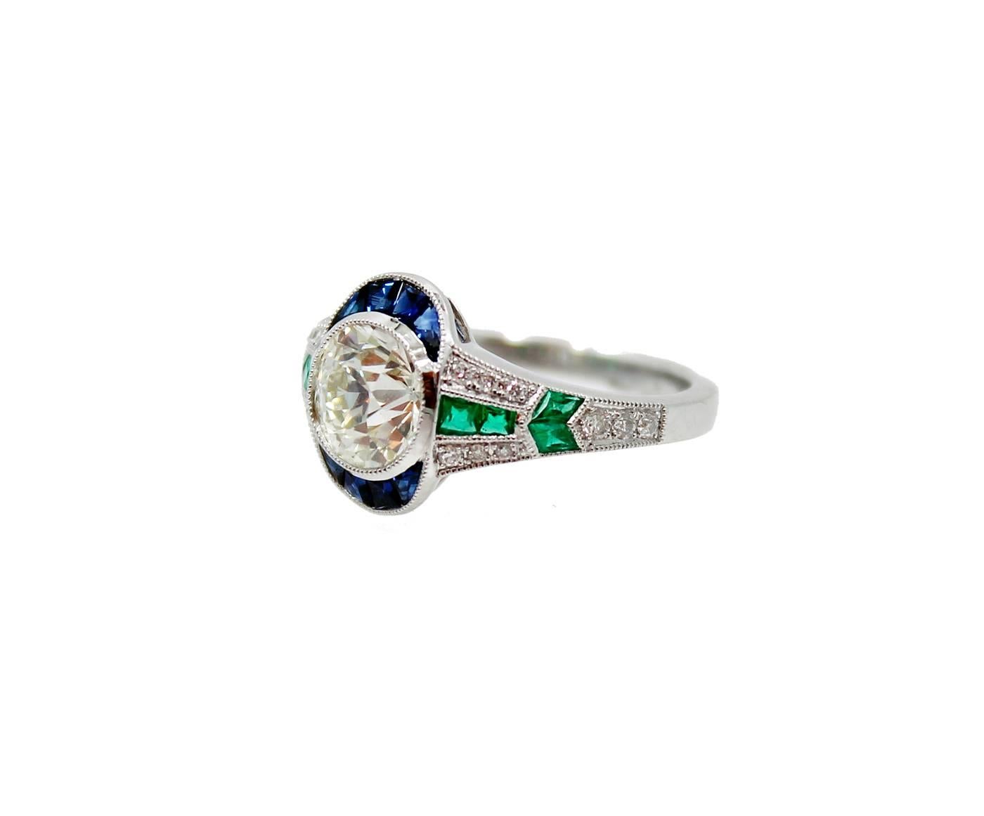 Art Deco Platinum Ring with a 1.57carat Old Mine Cut Diamond 8 Sapphires which equal .29 carats and 8 Emeralds which equal .29 carats. The ring is a size 7 and it is in pristine condition.