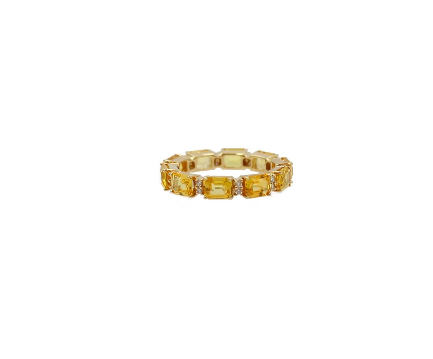 18K Yellow Gold Eternity Band with Ten Yellow Emerald Cut Sapphires and twenty Round Brilliant Diamonds. The yellow sapphires equal 4.94 carats and the diamonds equal .17 carats. The ring is a size 7 but available in other sizes. 