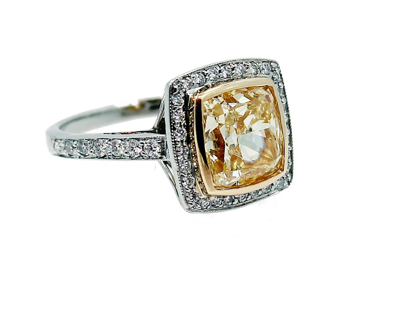 Platinum and 18K Yellow Gold Engagement Ring with a Fancy Light Yellow Radiant Diamond which weighs 5.55 carats and is SI2 in clarity. The center stone does have a GIA Report#2145418424 and the mounting has approximately .50 carat of round brilliant