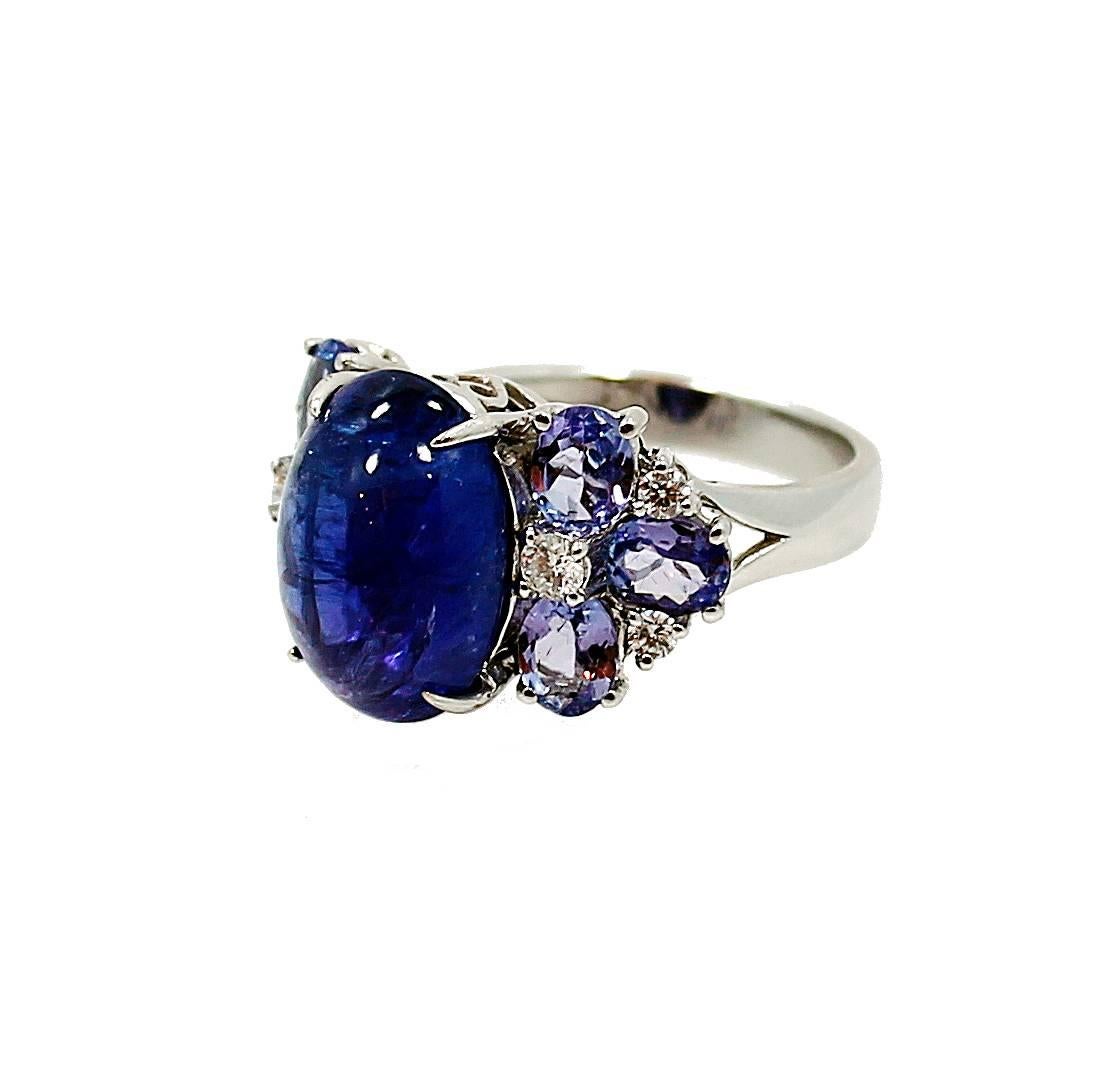 18K White Gold Ring with a Center 7.66 Carat Cabachon Tanzanite and side Tanzanites which equal 1.97 carats and Round Brilliant Diamonds which equal .26 carats. Beautiful ring and it is a size 7. It can be sized.