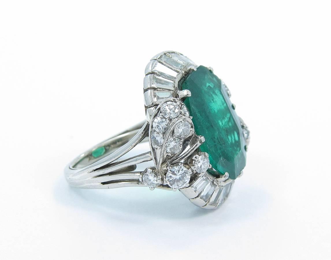 This beautiful estate ring holds a 5ct emerald fancy shape in the center with very nice color and pretty good clarity as you can see in the pictures. Surrounding this fancy cut emerald is approximately 3cts in diamonds of round brilliant cut and