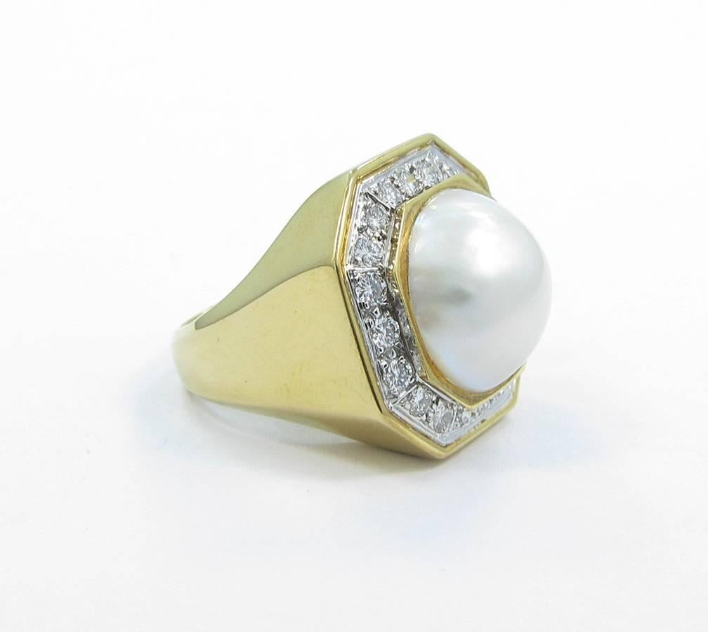 David Webb design. Mabe pearl ring with diamonds set in platinum in 18k yellow gold. Mabe pearl measures 16mm in diameter with a very nice white luster and shine. There are 20 round brilliant cut diamonds that are .05cts each giving this ring a