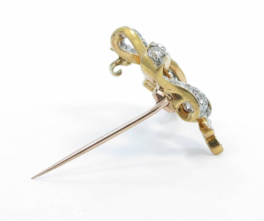 Up for sale is this beautiful antique 18k rose gold and platinum diamond bow pin. There is approximately 2.00cts total weight of old cut round diamonds which all have great quality. Hallmarks on the back are 