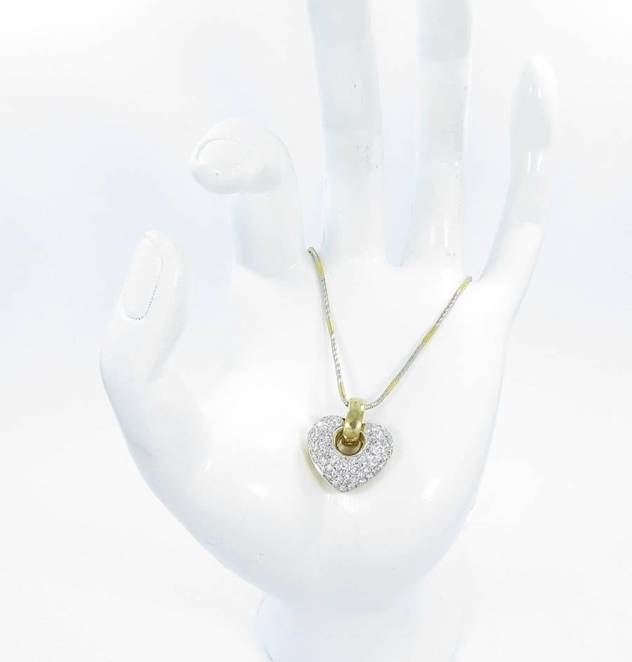 This beautiful Gregg Ruth pave diamond Heart necklace hold approximately 1.50cts of G-VS round brilliant cut diamonds prong set in 18k white gold soldered to the back carriage of 18k yellow gold. Heart measures .75 inches from left to right and .90