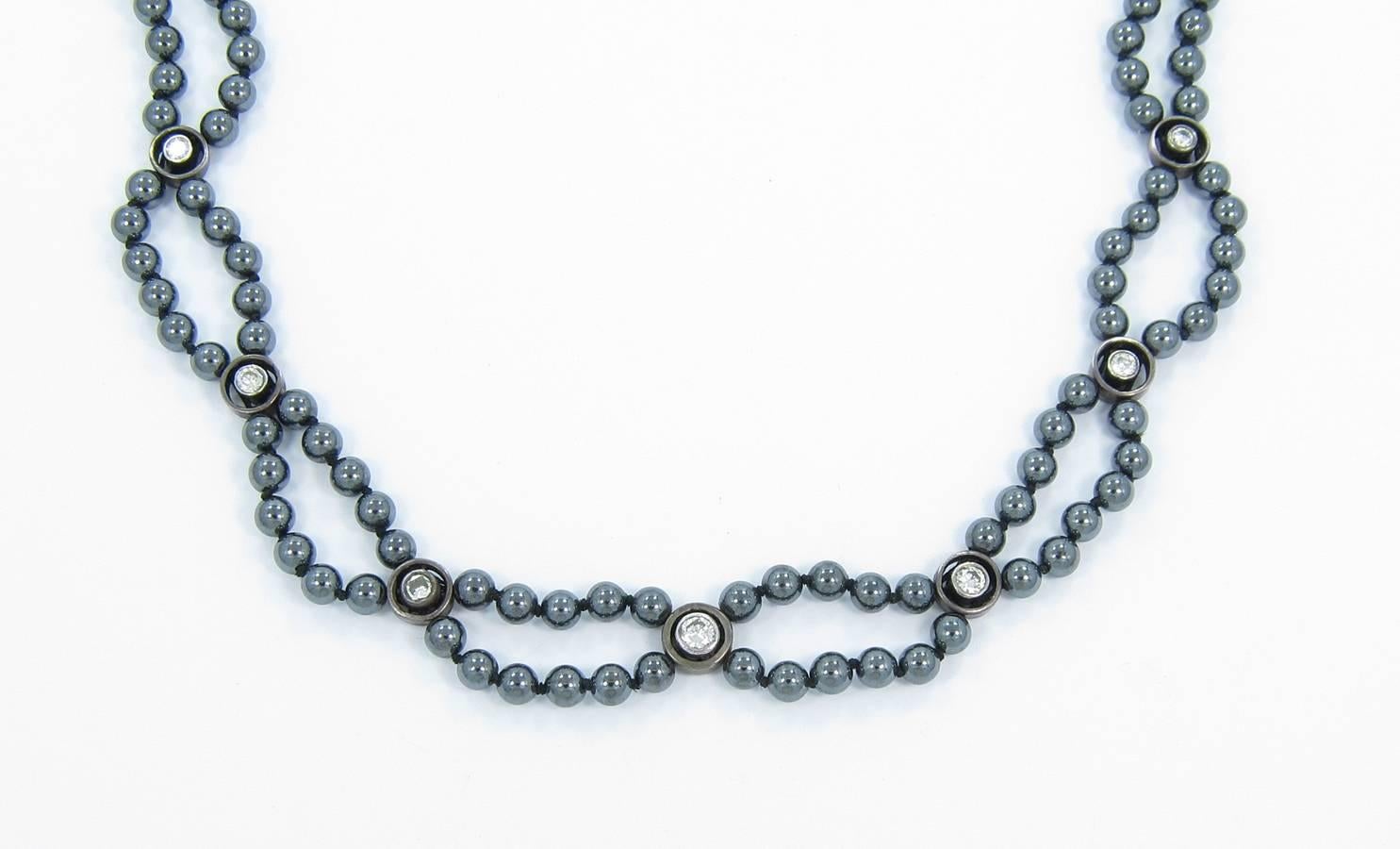 We are pleased to offer this Hematite bead necklace. All beads average 4.32mm in diameter and are held together by black, knotted cord. There are 8 diamonds on this necklace, each bezel set in sterling silver. All diamonds are old cut and graduate