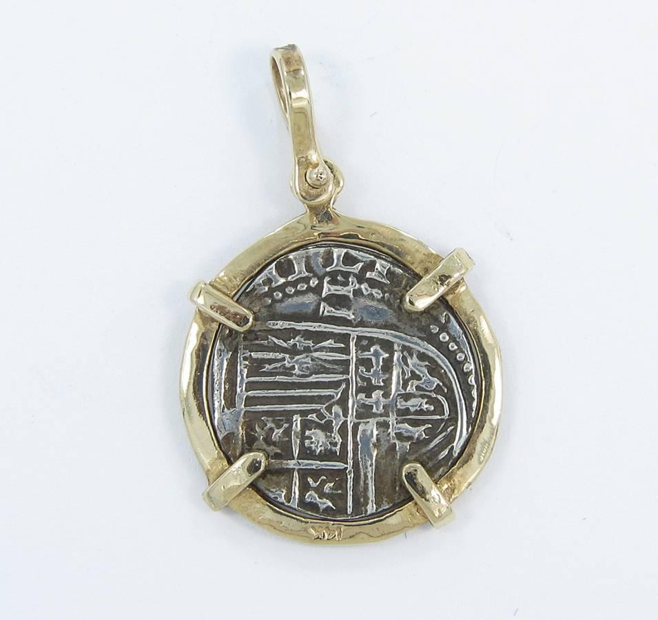 Up for sale is this Atocha Coin pendant with 14k yellow gold bezel and bail. Coin has measures roughly .75 inches in diameter. Entire pendant measures .87 inches in diameter and weighs a total of 5.3 grams. This rugged coin has a rugged bezel to