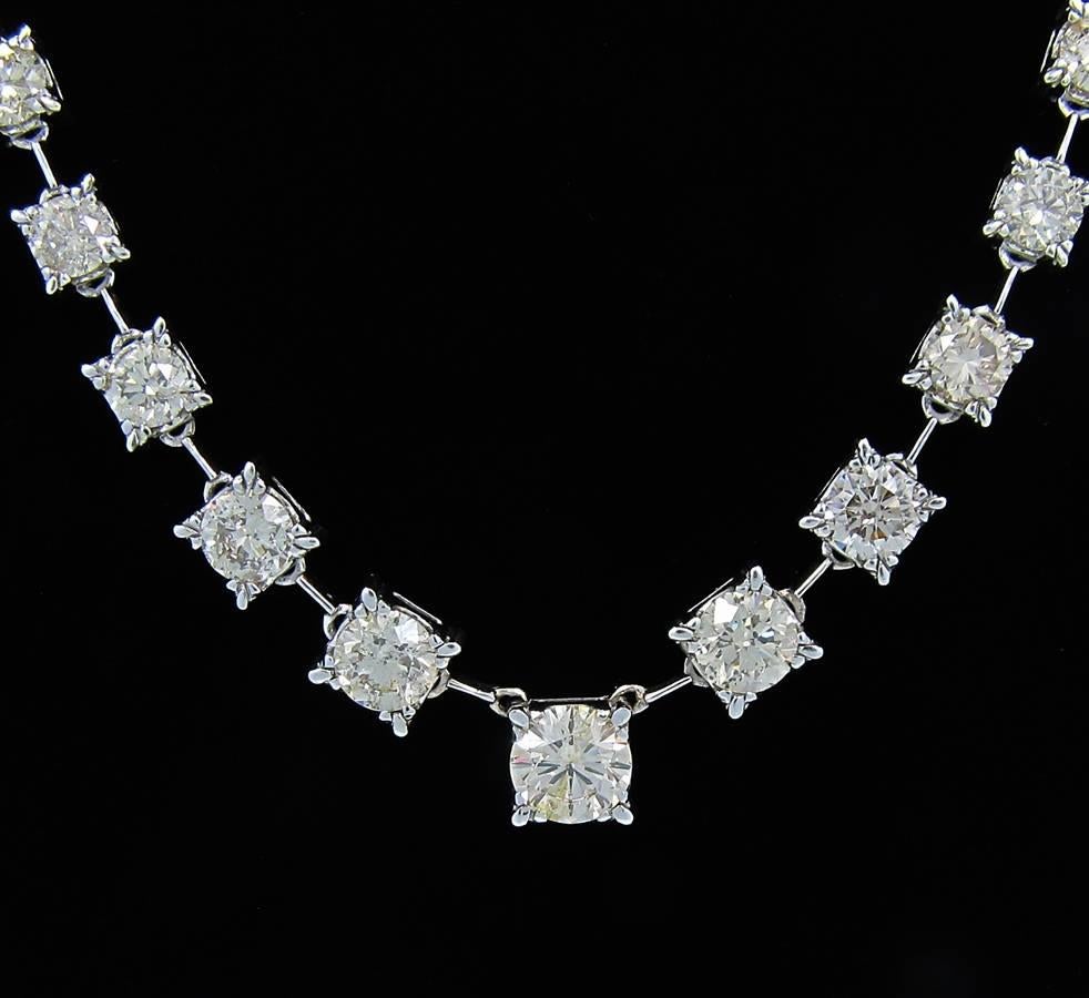 Yes this necklace is eye catching and very impressive. Center diamond is approximately 3.17cts and then they graduate to the smallest around .80cts. There are a total of 37 round brilliant cut diamonds. There quality is within the range of color