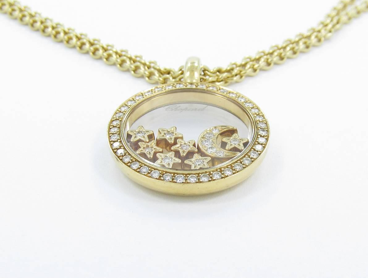 Chopard Happy Diamond Moon and Stars Pendant in 18k yellow gold. Pendant holds a total of 51 Round brilliant cut diamonds with VS1 Clarity and G color. Total diamond weight is .59cts. Chain length is 16