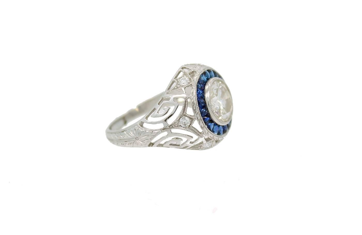 Platinum Ring with 20 French Cut Blue Sapphire's weighing a total of .71 carat's, a Center Round Top Light Brown Diamond weighing 2.05ct and SI in clarity. The Hand Carved Mounting has a total of 6 diamonds which weigh .14ct in total. Very