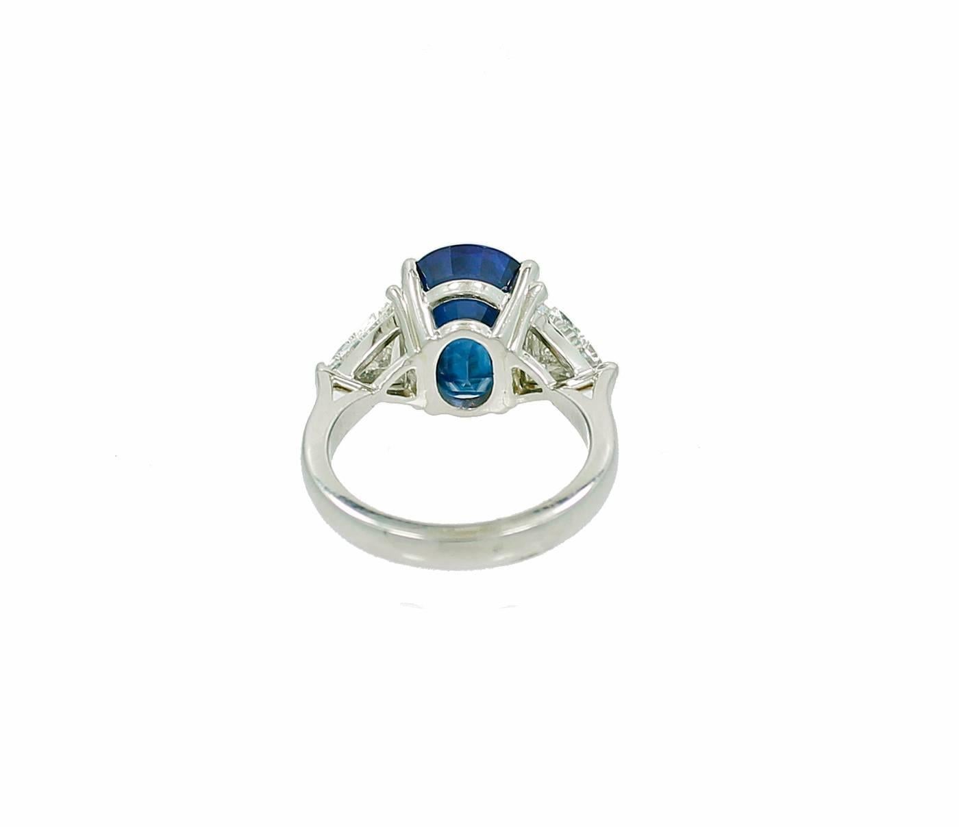 Platinum Ring with a Center Ceylon Sapphire weighing 7.08ct and two trillion Cut Diamonds weighing a total of 1.61ct I Color VS Clarity. This ring is a size 6.5 and can be sized up or down upon request. 