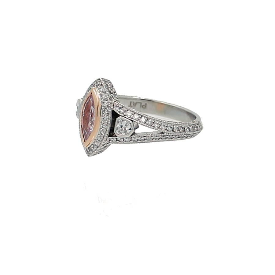 Platinum Ring with Marquise Modified Brilliant Fancy Purplish Pink Diamond weighing .40ct with GIA Report#14780625. The mounting contains 170 Round Brilliant Cut Diamonds weighing a total of .65ct with two trapezoid diamonds weighing .16ct in total.