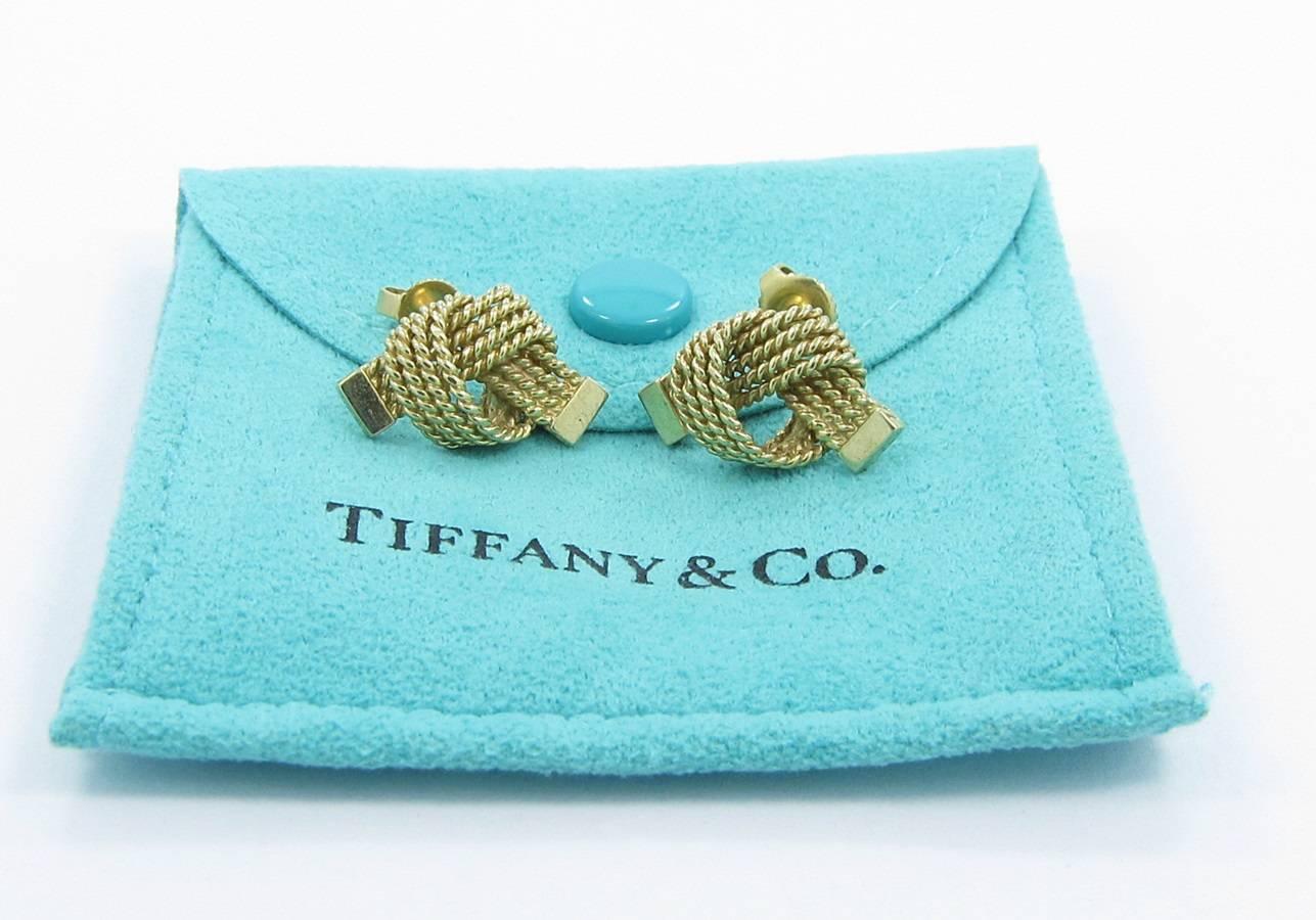 We are pleased to offer these beautiful authentic Tiffany & Co. Love Knot Rope Earrings. Earrings are constructed in 14k yellow gold with push backings. Earrings are in good condition with little sign of wear. Earrings measure .75