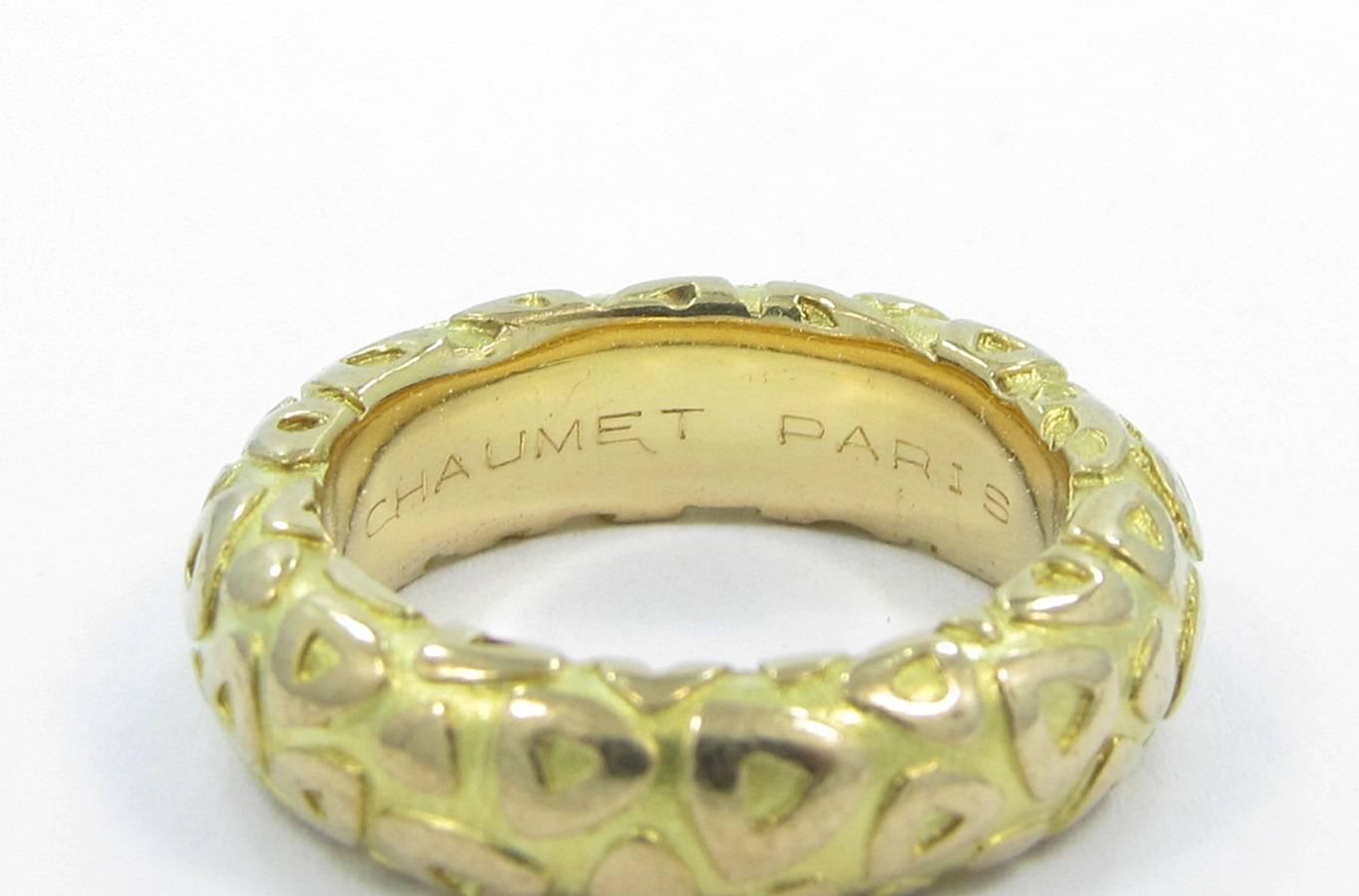 Chaumet Paris Triangle Motif band is created in 18k yellow gold. Ring show light signs of wear with minor scratches. Ring is stamped with the serial number of 