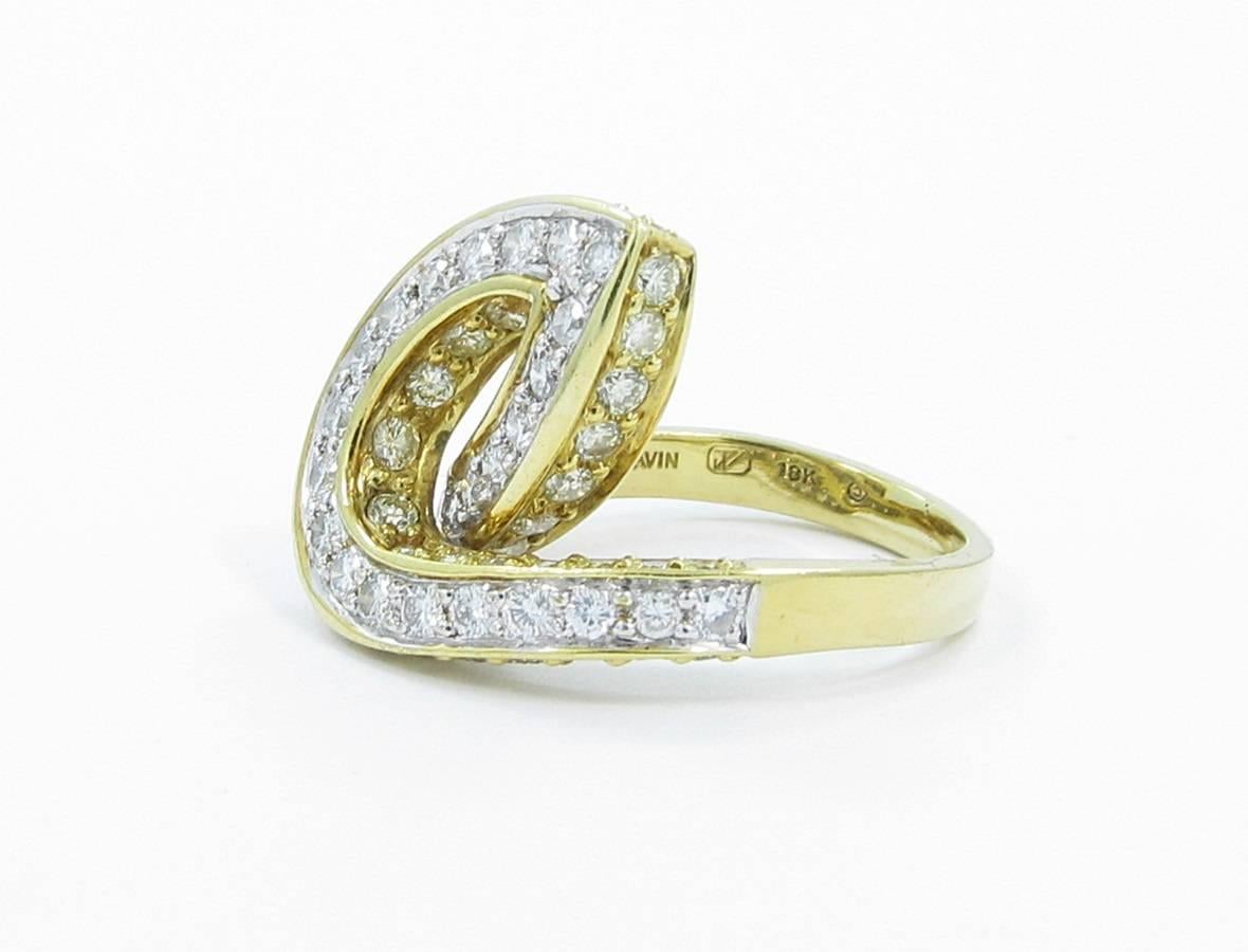 This rings is made of 18k yellow gold with the top row of diamonds set in 18k white gold. Ring is stamped 