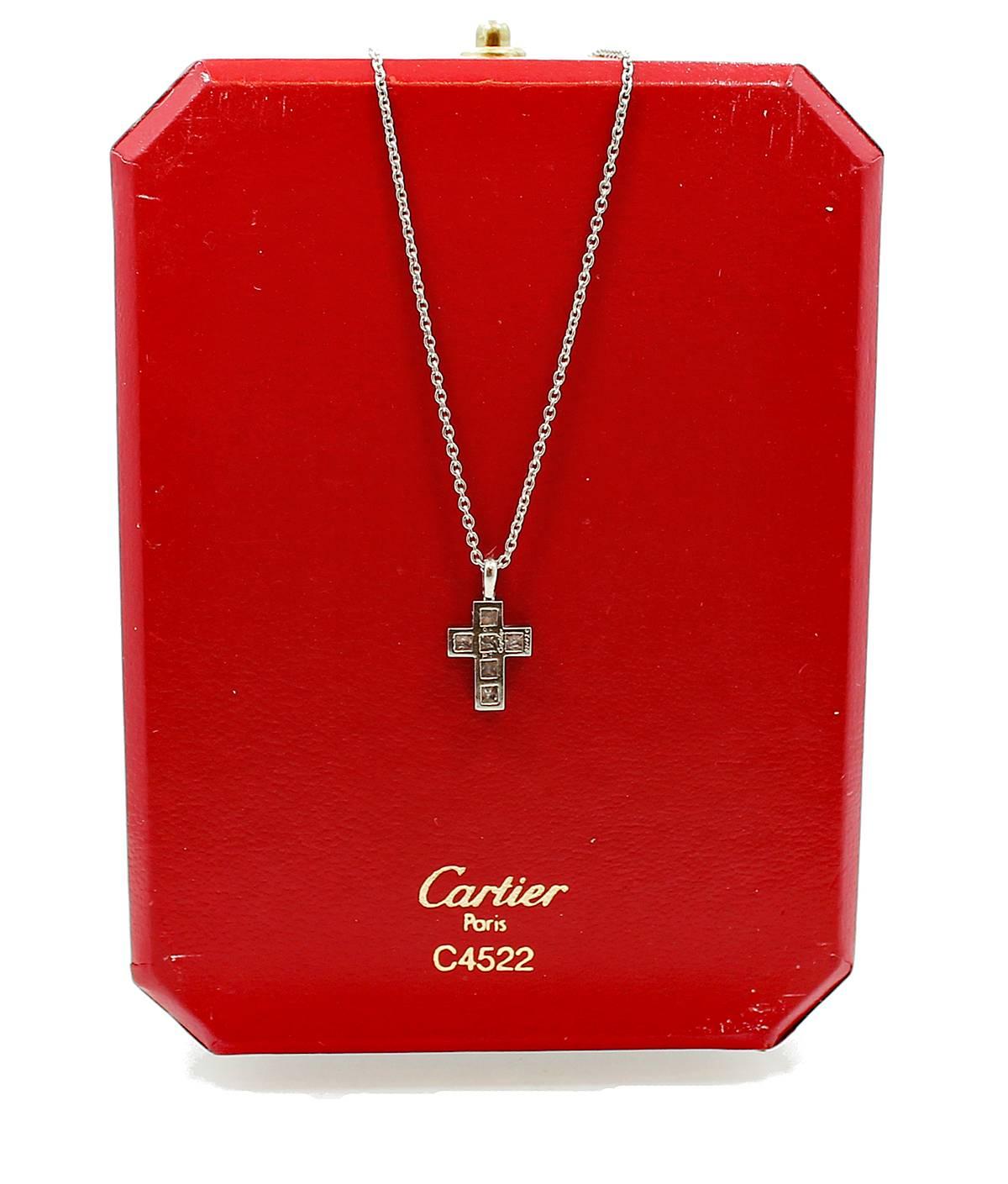 Signed Cartier Platinum Cross Pendant with 6 Square Cut Diamonds which are equal to .70 carats F in color and VVS in clarity. This fine Cartier pendant is also numbered C71026 and comes in original box with 16 inch Platinum Chain. 