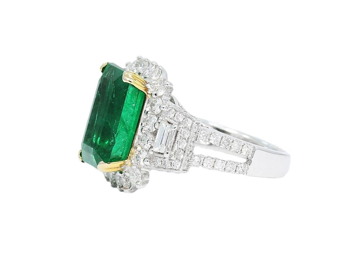 
This astounding ring hold a 6.65ct center emerald with beautiful vibrant color. Surrounding the center emerald are round and baguette diamonds that are near colorless and VS quality. Please take a look at all of the pictures and ask any questions