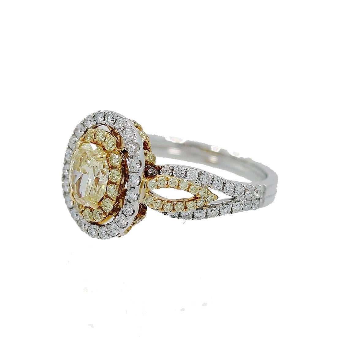18K Yellow and White Gold Engagement Ring with a Center Oval Fancy Intense Yellow Diamond which weighs .80 carats and Round Brilliant Yellow and White Diamonds with a total of 1.31 carats. The Center Diamond has a EGLUS report #68695802. The ring is