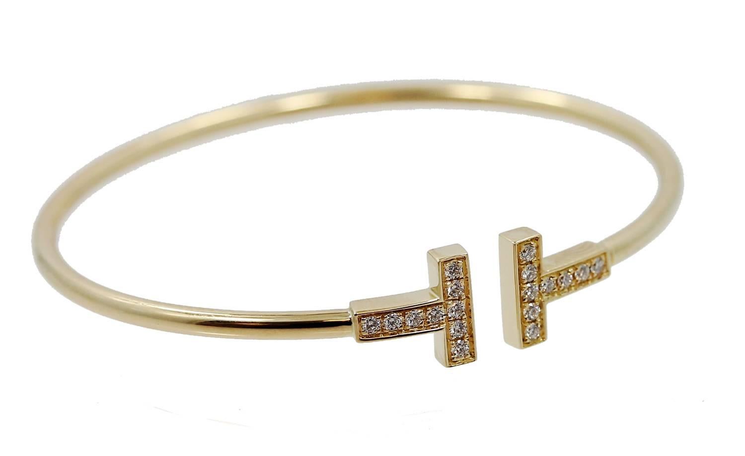 18K Yellow Gold Tiffany & Co. T Gold Bracelet with Diamonds weighing a total of .22 carats. This bracelet is a size medium and fits a wrist up to 6.25