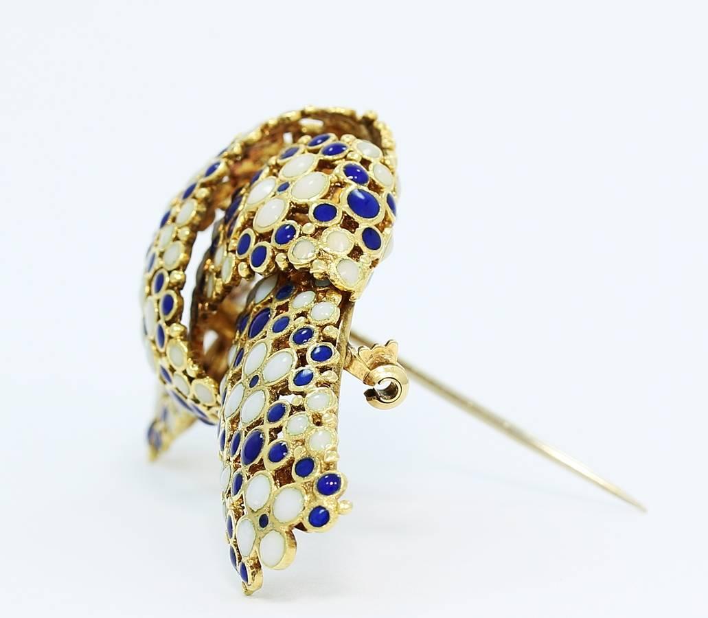 Here is another example of the beautiful creativity from the makers of Tiffany & Co. This pin has a flowing flower design created using white and blue dot enameling which wraps around there unique knot design. Locking pin on back is in excellent