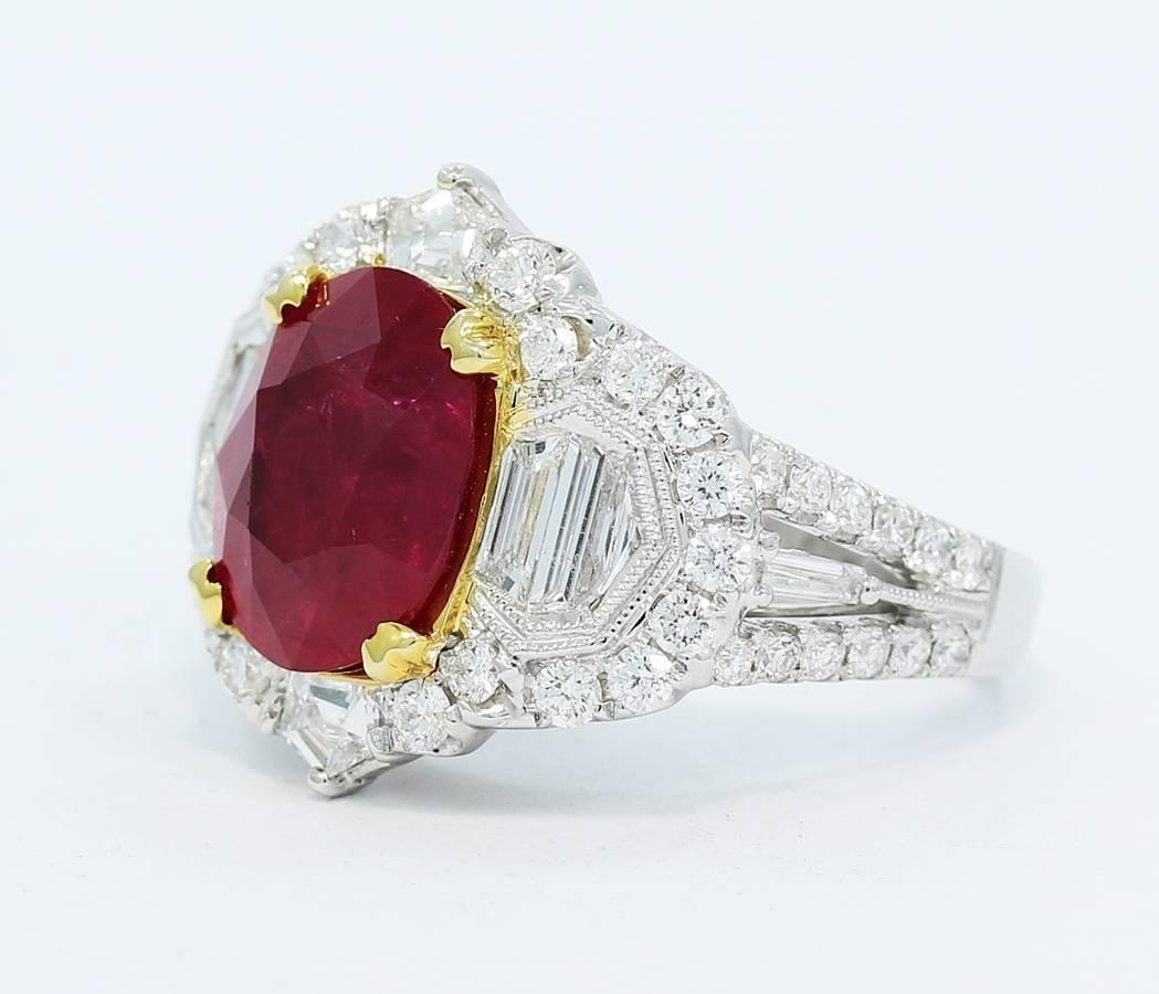 This ring holds a beautiful 5.50ct oval ruby in the center with very nice color and clarity. Surrounding the ruby are mixed round and baguette cut diamonds that equal 2.25cts total. All stones are very securely set in the 18k gold. The quality and