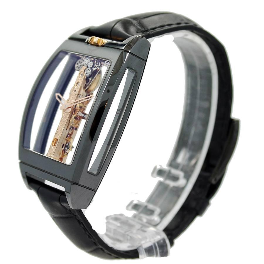 Corum Bridges Golden Bridge Ceramic Case Watch. This watch is 34mm x 51mm in Black Cearmic and 5N 18K red gold Movement and Crown.  The watch is 11.35mm thick, transparent back with glare proof sapphire crystal, black ceramic bezel, clear dial and