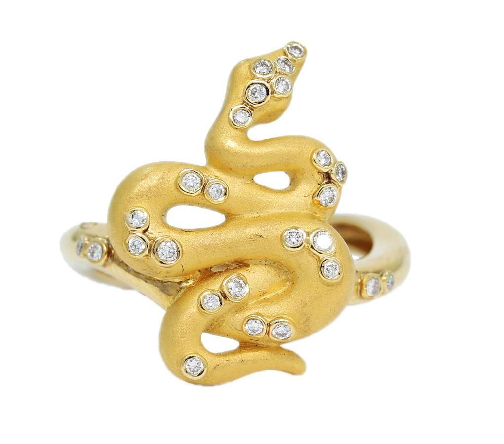 This Carrera y Carrera Snake Ring is constructed in 18k yellow gold with scattered diamonds and two ruby eyes. You can see all hallmarks in pictures provided. From head to tail the snake measures .75