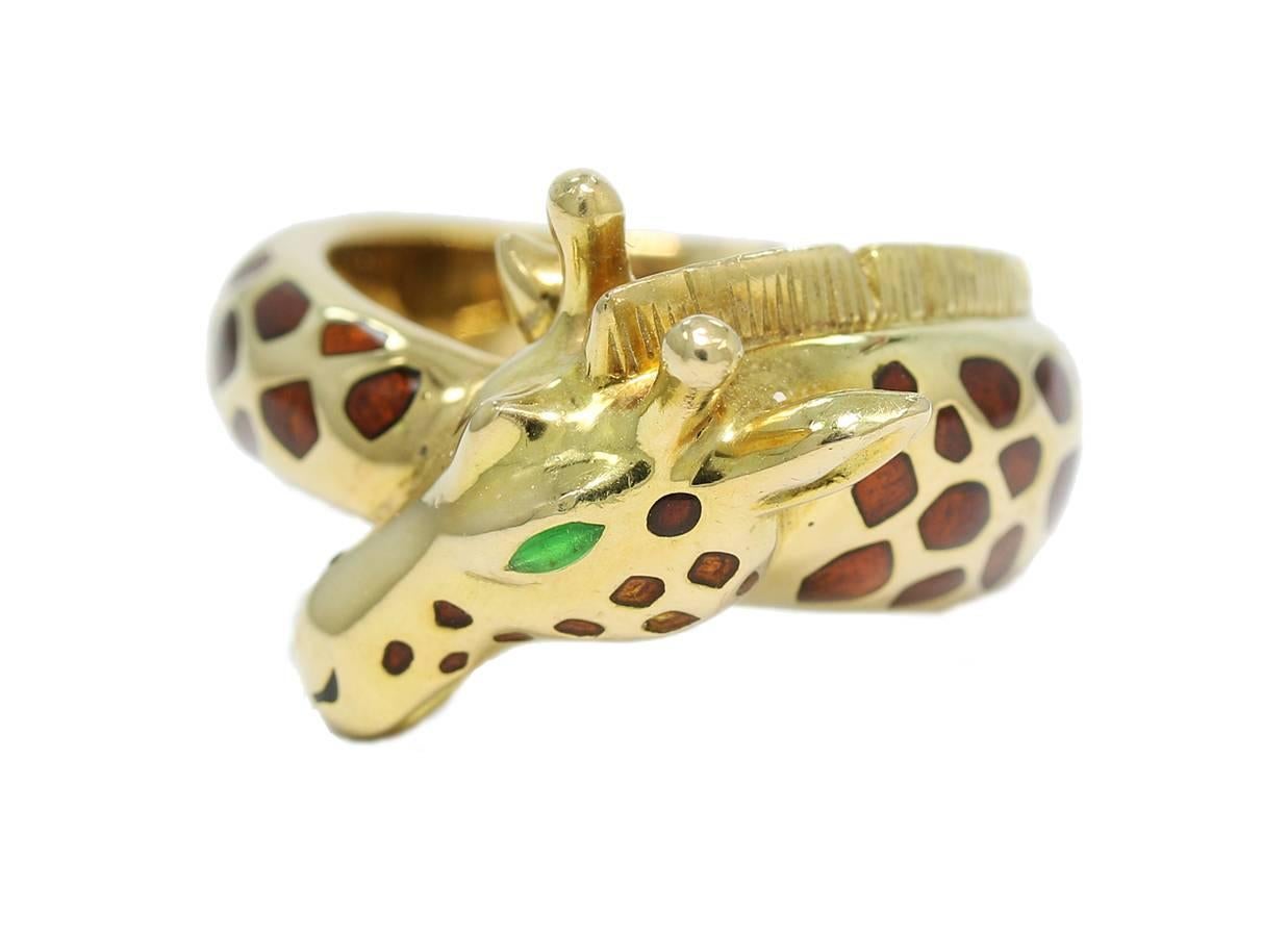 This hard to find Hermes Giraffe Ring is created in 18k yellow gold. The body of this giraffe has brown polychrome enamel which is inset for a smooth finish. The eyes are created with the green enamel. This ring is stamped 