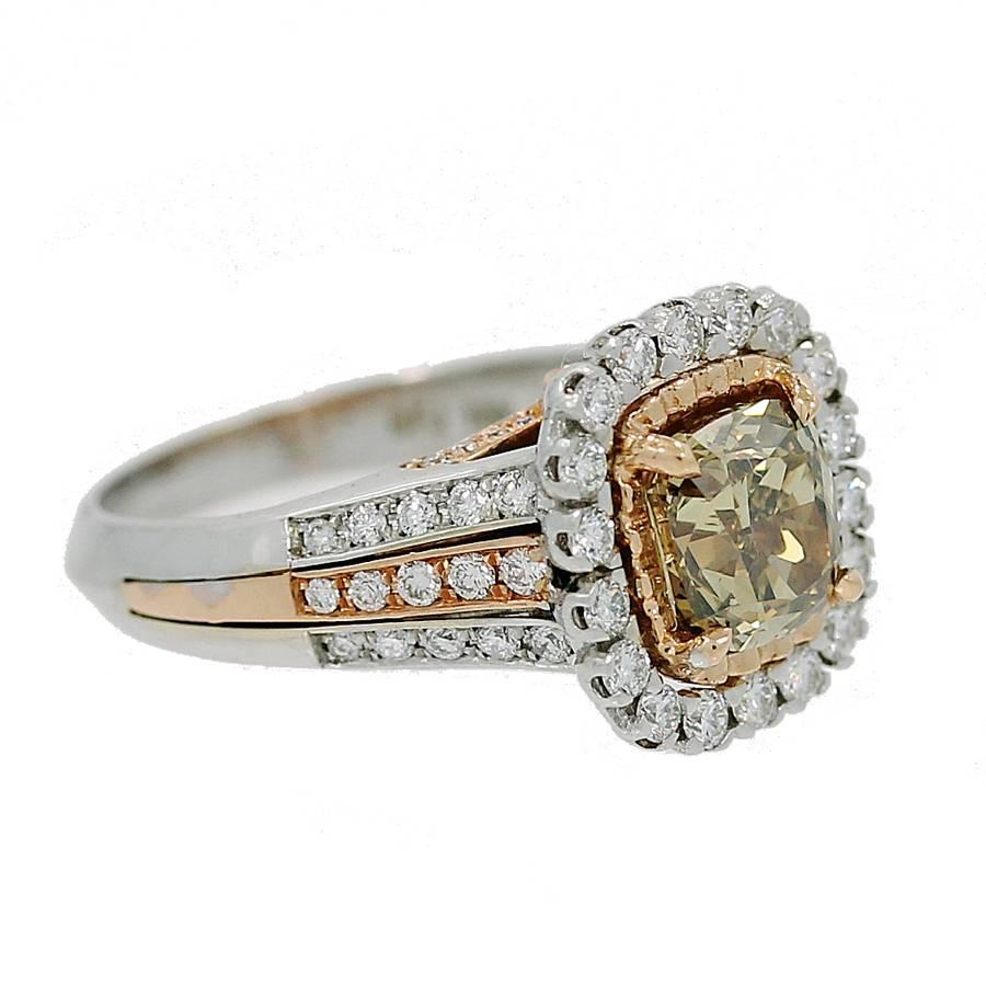 18K White and Rose Gold Ring with a Cushion modified Brilliant Cut 1.71 carat Diamond. This Diamond is a Natural Fancy Dark Greenish Yellow brown Color and SI1 in Clarity. It has a EGLUS Report#310435302D and features Round Brilliant cut Diamonds on