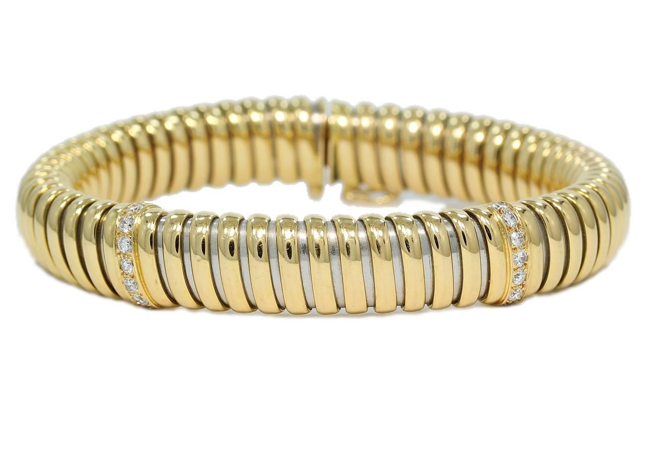 Cartier 18k two-tone Diamond Ribbed Flexible Bracelet. Bracelet is constructed of 18k yellow gold and 18k white gold with the signature 