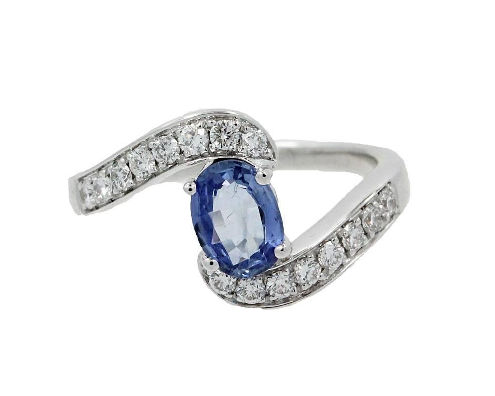 18K White Gold Ring with a Center Sapphire 7x5 mm and Round Brilliant Diamonds equal to .35 carats total weigh. Very simple and elegant ring. It is a size 7 but can be sized upon request. 