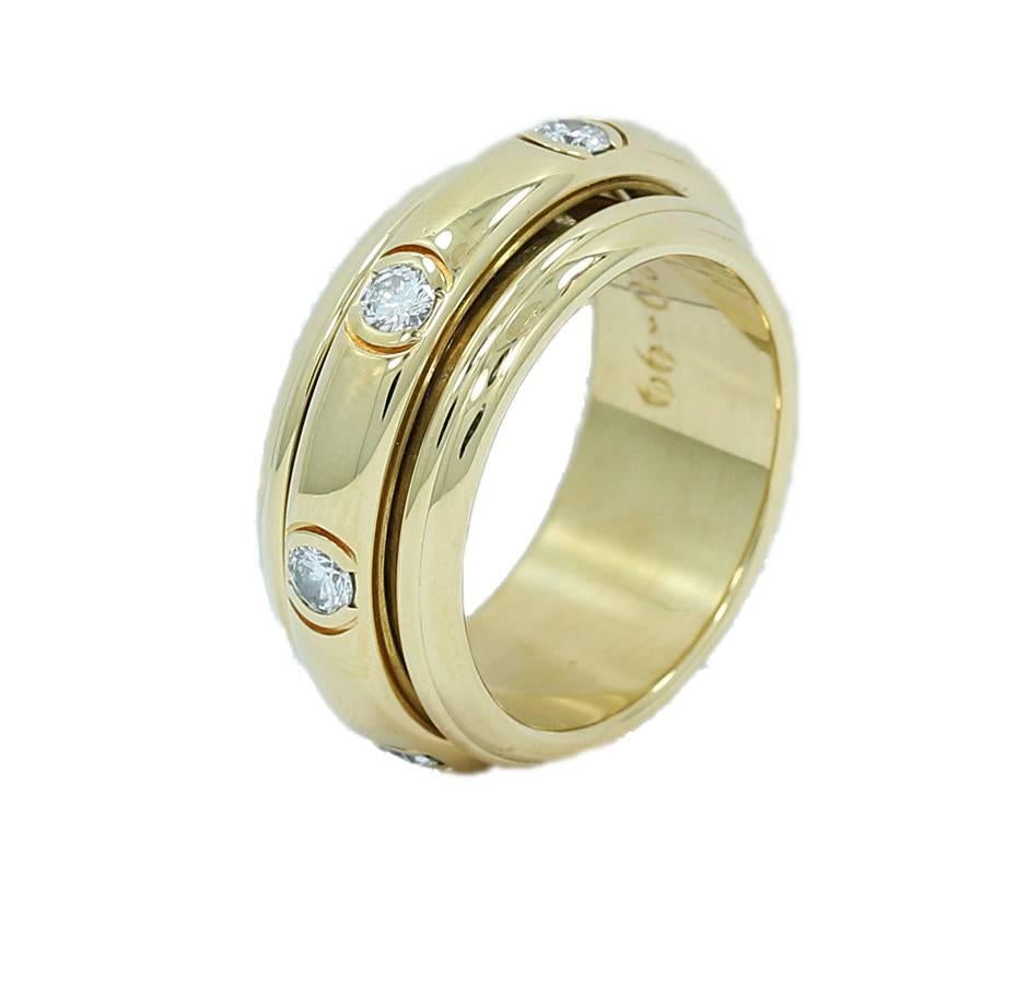 Up for sale is this Piaget 18k yellow gold diamond spinner ring. This ring holds seven (7) round brilliant cut diamonds securely half bezel set. Ring sits at a size 10.5 It measures 1.125" in width and has a total weight of 21.1 grams. It is