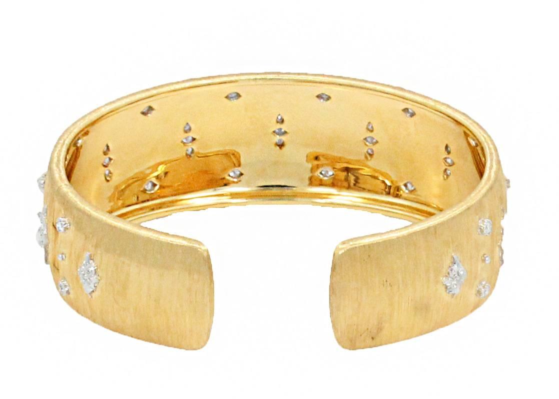 18K Yellow Gold Buccellati 2cm Cuff Bracelet With 47 Round Brilliant Cut Diamonds Weighing 0.94ctw Set in White Gold Bezels. This Cuff Bracelet Fits a 6inch Wrist.