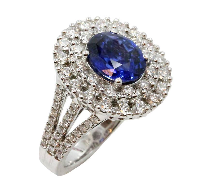 18K White Gold Ring With Oval Center Sapphire Stone Weighing 3.09ct and Surrounding Diamonds Weighing 1.99ct. This Ring Is a Size 7.