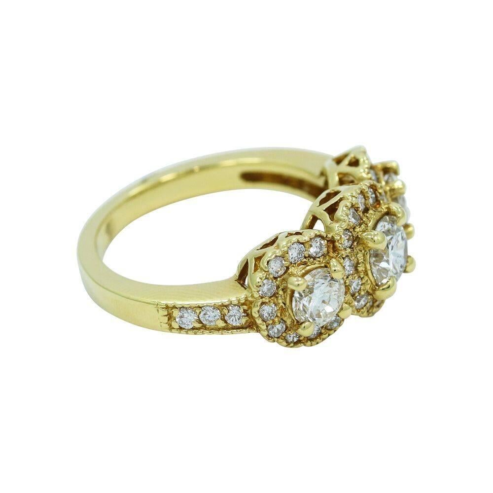 Up for sale is this beautiful 18k yellow gold three (3) stone ring. Center diamond weighs 0.63 carats J/I1, two (2) round brilliant cut diamonds weigh approximately 0.72 carats total weight H/SI2, and thirty seven (37) diamonds weighing