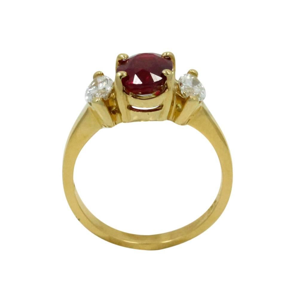 18K Yellow Gold Ring With Center Oval Ruby With a Total Carat Weight of 1.25ct and Two Diamonds With a Total Carat Weight of 0.55ct. This Ring is a Size 6.