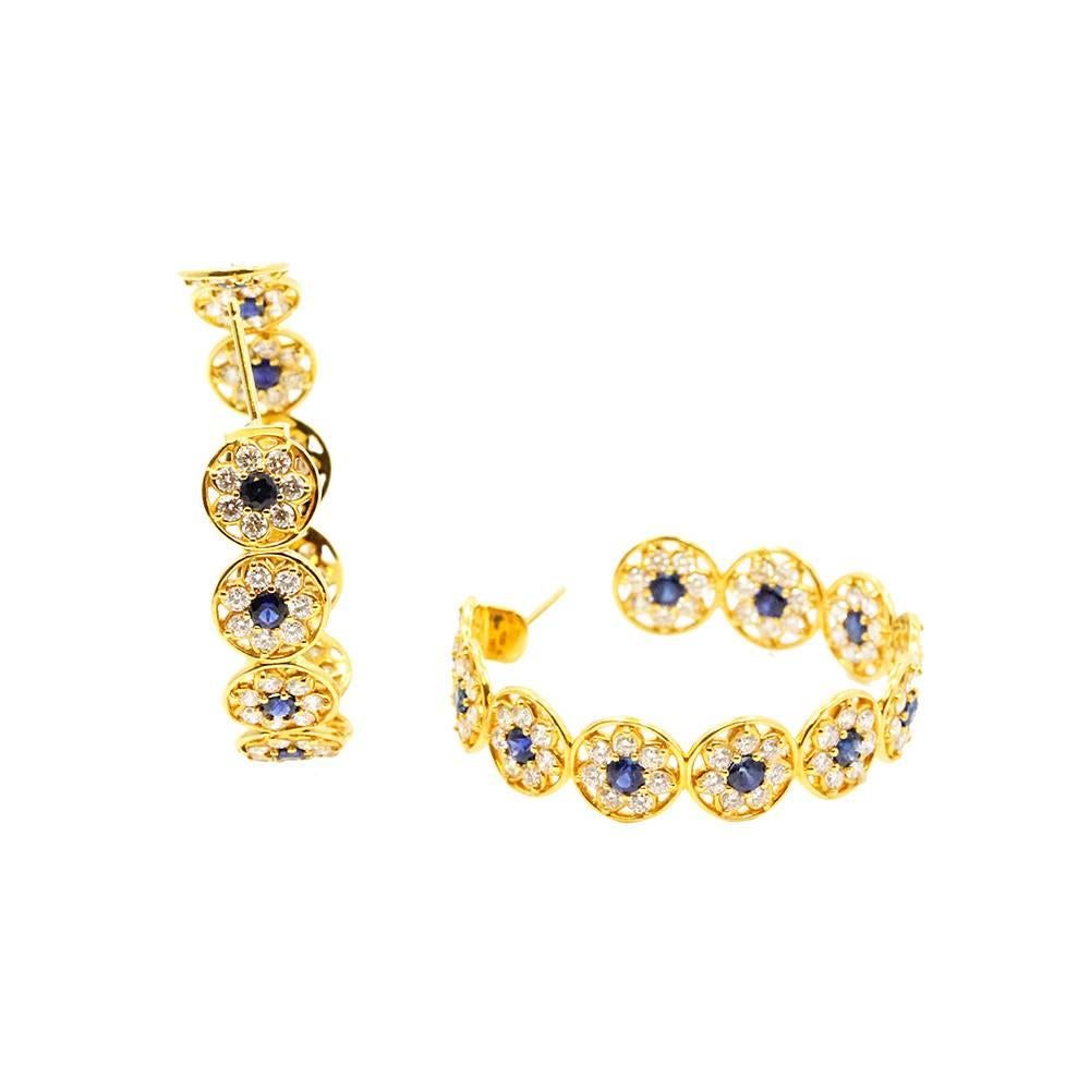 20K Yellow Gold Buddha mama Continuous Flower Hoop Earrings With White Diamonds Weighing A Total Carat Weight Of 4.77ct and Blue Sapphires Weighing A Total Carat Weight Of 3.13ct.