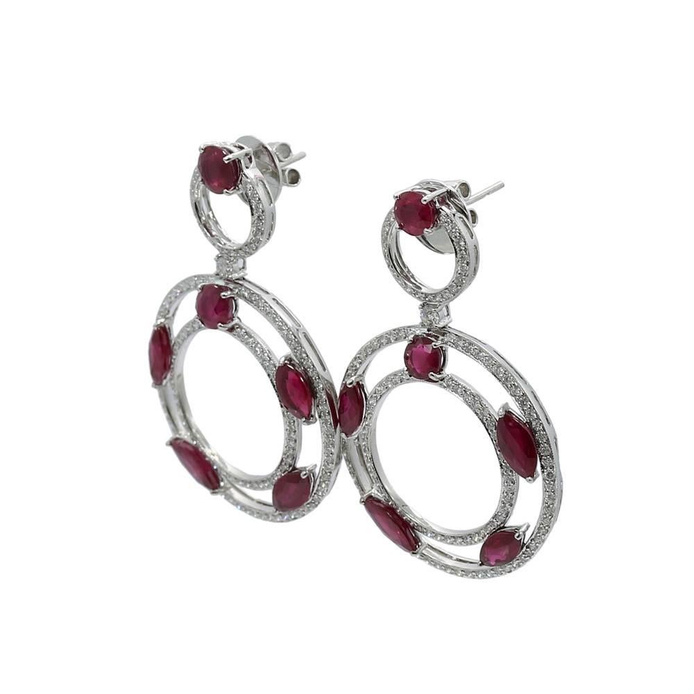 We have these beautiful 18k white gold diamond and ruby dangle earrings. Rubies weigh approximately 13.27 carats total weight and the diamonds weigh 3.02 carats total weight. They measure 2.125" in height with a total weight of 23.4 grams. The