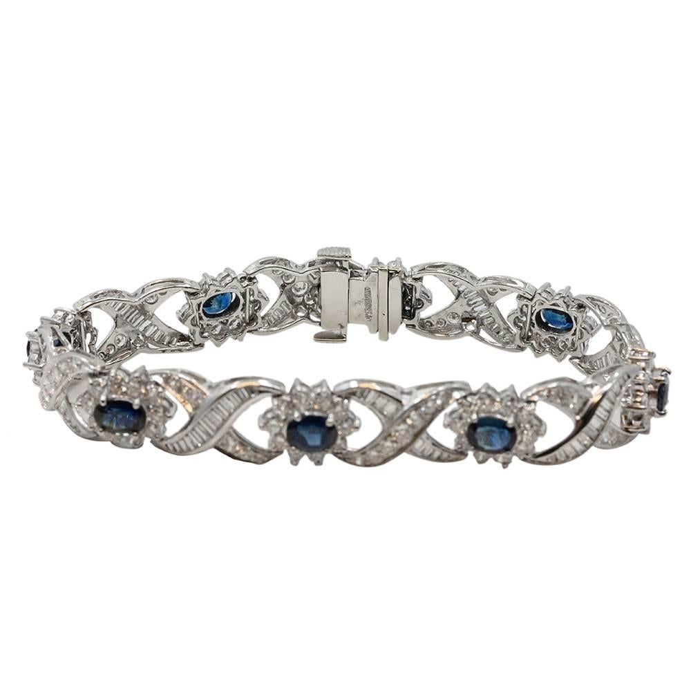 Platinum Bracelet With 8 Oval Sapphires Weighing A Total Carat Weight Of 4.00ct and 218 Surrounding Diamonds Weighing A Total Carat Weight Of 9.25ct G/H In Color And VS2/SI1 In Clarity. The Length Of This Bracelet is 8 Inches.