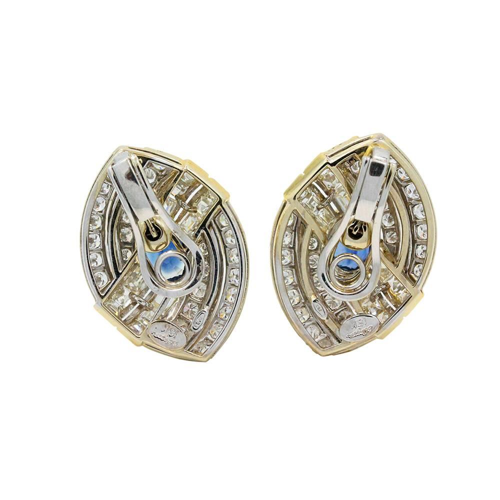 18K Stud Earrings With A Center Kancha Heated Blue Sapphire Weighing A Total Carat Weight Of 4.07 And Carre Cut Diamonds Weighing A Total Carat Weight Of 10.00ct With F-H In Color And VS1 In Clarity.