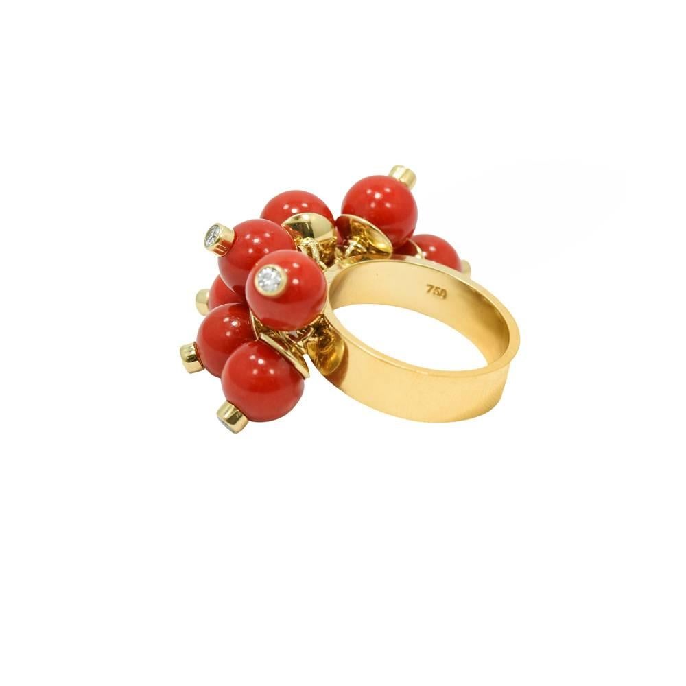 Up for sale is this 18k yellow gold mediterranean coral and diamond beaded ring. The diamonds weigh approximately .45 carats total weight. Ring sits at a size 6.5 and can be easily sized. It weighs a total of 16.0 grams. The ring is in great