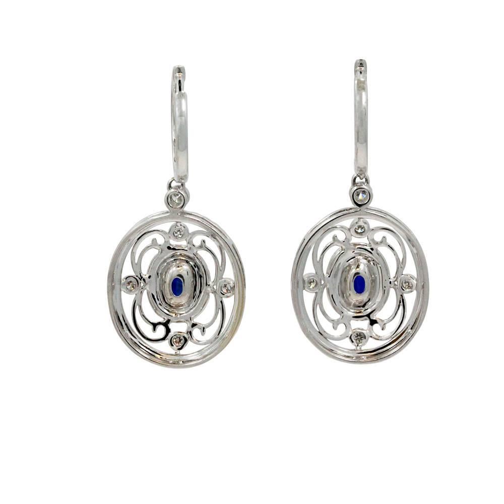 18K White Gold Earrings With Center Blue Sapphire Weighing A Total Carat Weight Of 2.10ct And White Round Diamonds Weighing A Total Carat Weight Of 1.30ct.