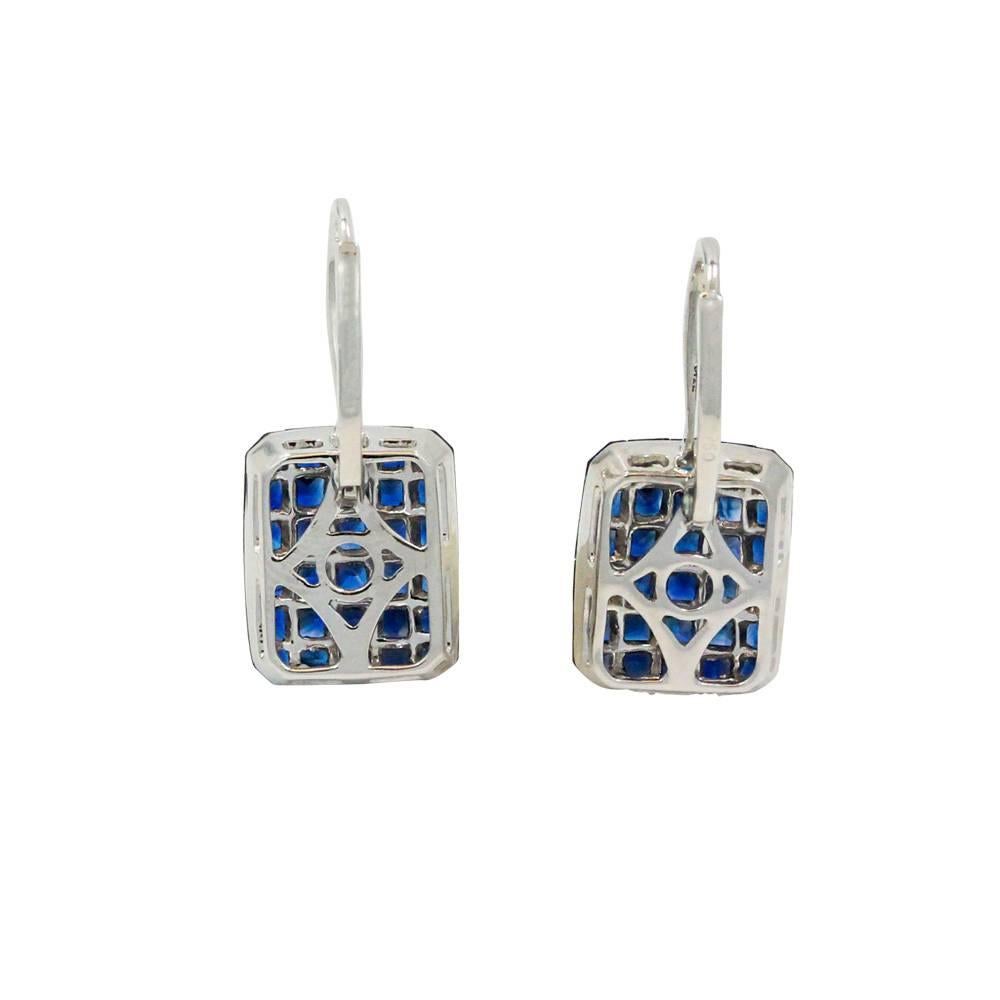 18K White Gold Earrings With Invisible Set Sapphires Weighing A Total Carat Weight Of 6.12ct And Round Diamonds Weighing A Total Carat Weight Of 0.14ct