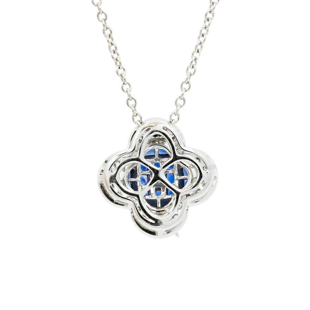 18K White Gold Invisible Set Blue Sapphires Weighing A Total Carat Weight Of 1.50ct And Surrounding Diamonds Weighing A Total Carat Weight Of 0.18ct Pendent On A 16" Chain.