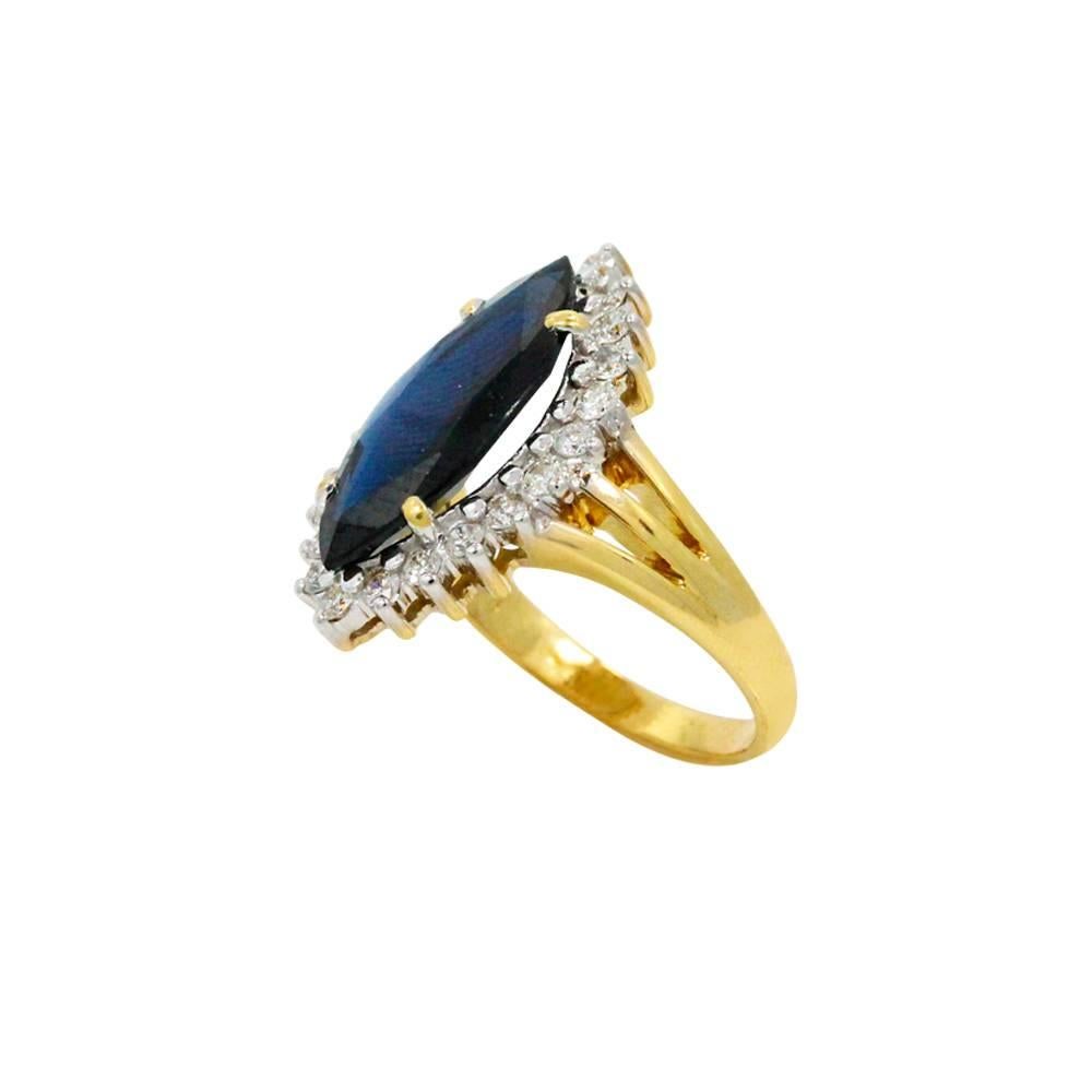 18K Yellow Gold Ring With Center Blue Sapphire With A Total Carat Weight Of 3.60ct And 22 Surrounding DIamonds With A Total Carat Weight Of 0.50ct And H-I In Color And SI In Color.