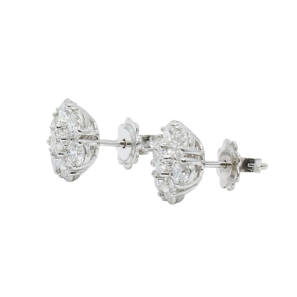 We have these beautiful 18k white gold diamond flower cluster earrings. The diamonds weigh approximately 2.80 carats total weight with a total weigh of 4.2 grams. They measure 0.75" in length x .5" in height. These earrings are in