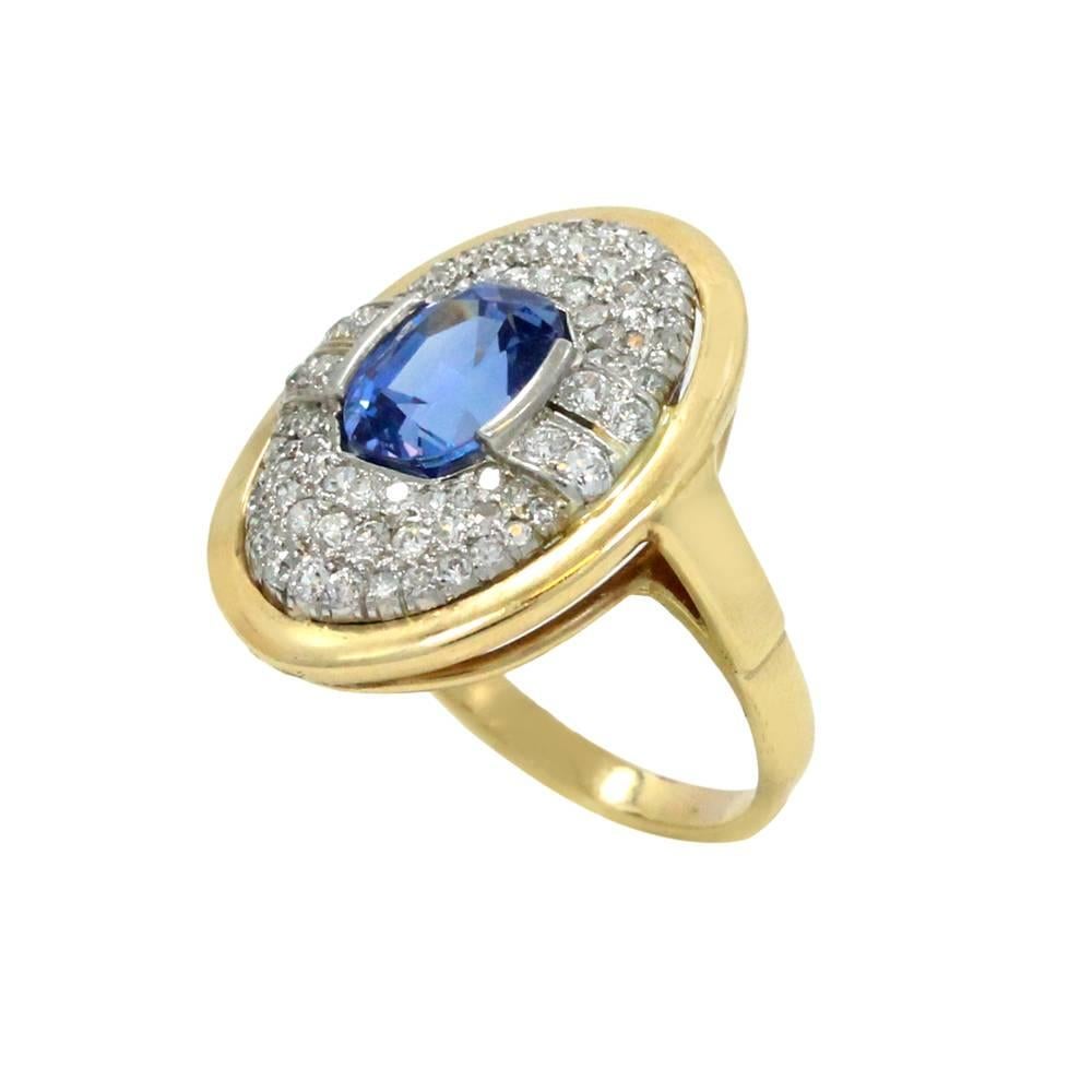 18K Yellow Gold Ring With Center Oval Sapphire In The Center Weighing A Total Carat Weight Of 2.58ct And Surrounding Diamonds Weighing A Total Carat Weight Of 0.1ct.