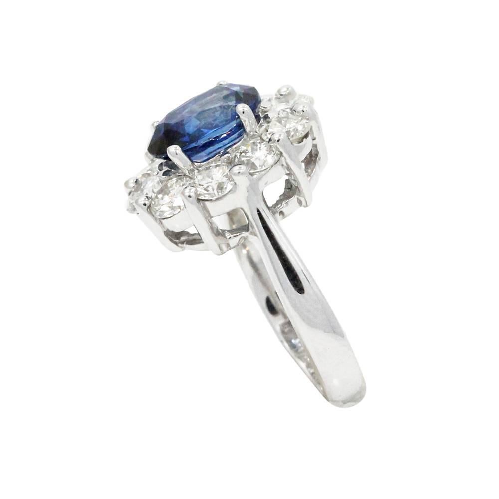 18K White Gold Ring With Center Oval Sapphire Weighing A Total Carat Weight Of 2.54ct And Surrounding Diamonds Weighing A Total Carat Weight Of 1.67ct. This Ring Is A Size 4.5
