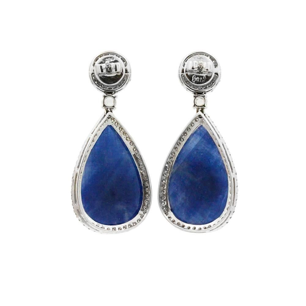 18K White Gold Earrings With Pear Shaped Sapphires Weighing A Total Carat Weight Of 41.24ct And Surrounding Diamonds Weighing A Total Carat Weight Of 1.69ct With G-H In Color And SI1 In Clarity.
