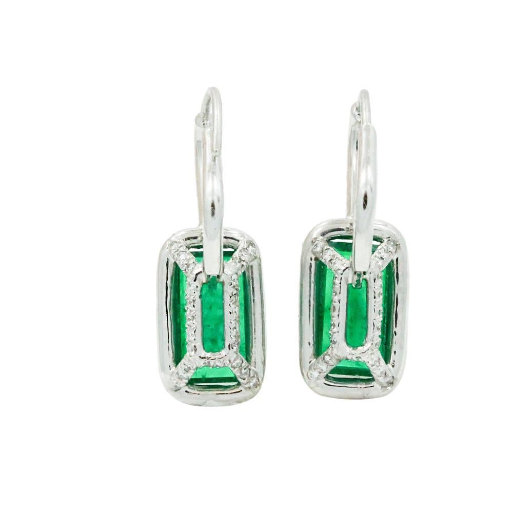 Platinum Earrings With Emerald Cut Emeralds In The Center With A Total Carat Weight Of 3.84ct And Surrounding Diamonds Weighing A Total Carat Weight Of 0.74ct With G In Color And VS In Clarity. These Earrings Are 1 Inch In Length.